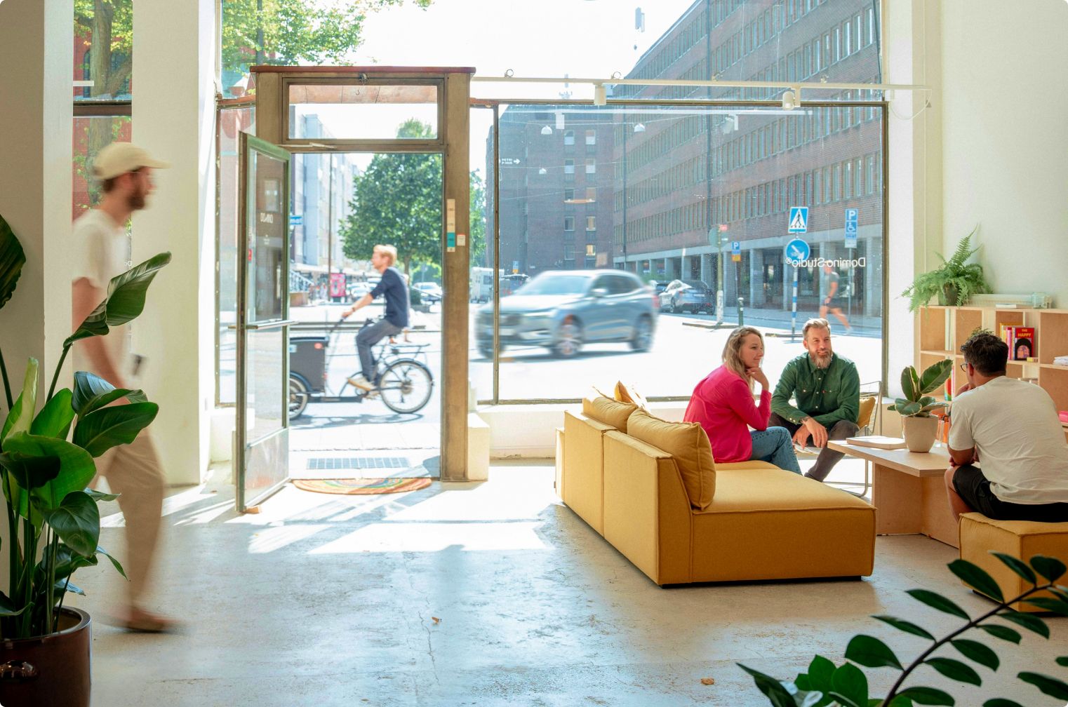An agency team meeting clients in a bright storefront studio